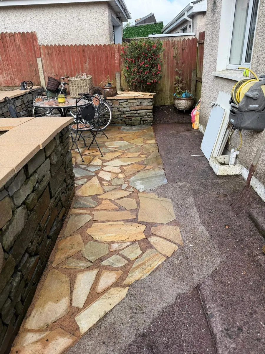 Completed garden renovation showing new lawn turf sod and patio paving