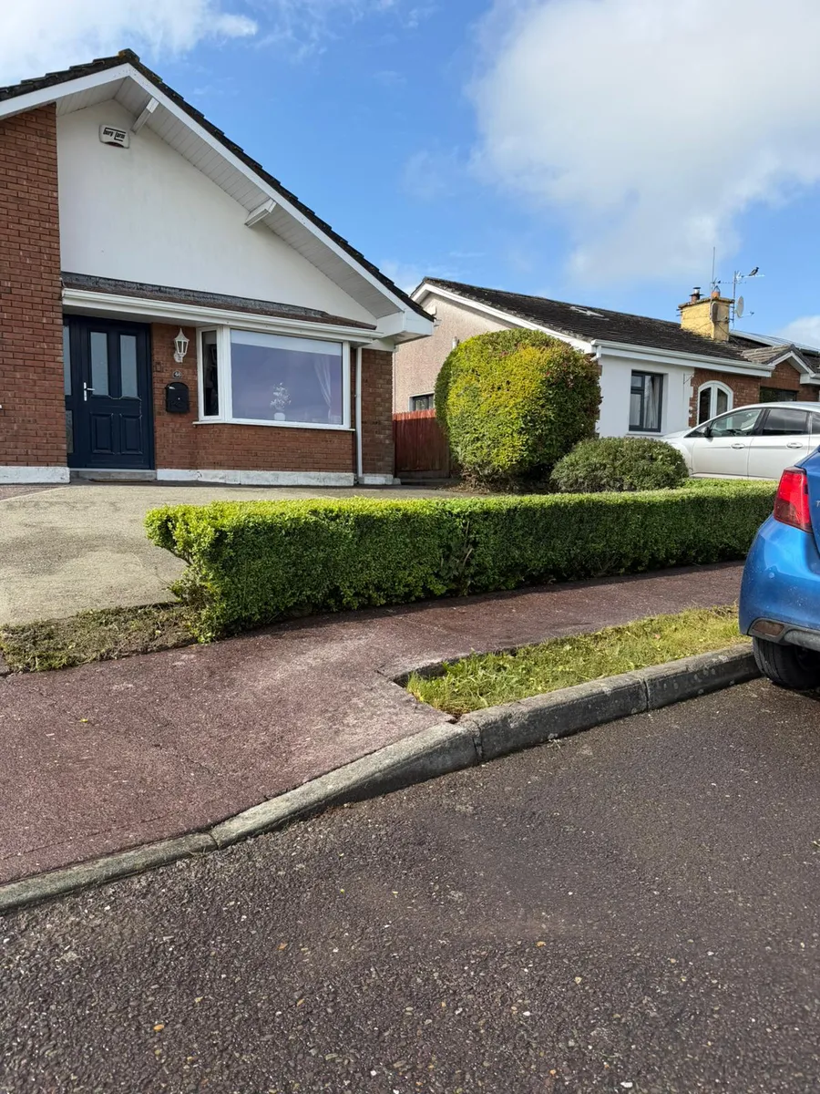 Completed wooden boundary fence installation on a concrete base wall